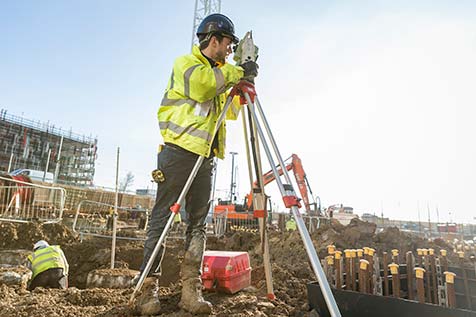 Building in construction with crane