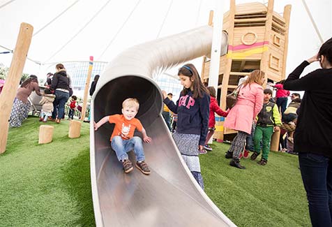 Child enjoying slide in playpark